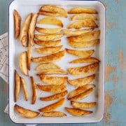 an overhead shot of oven baked French fries on a baking sheet.