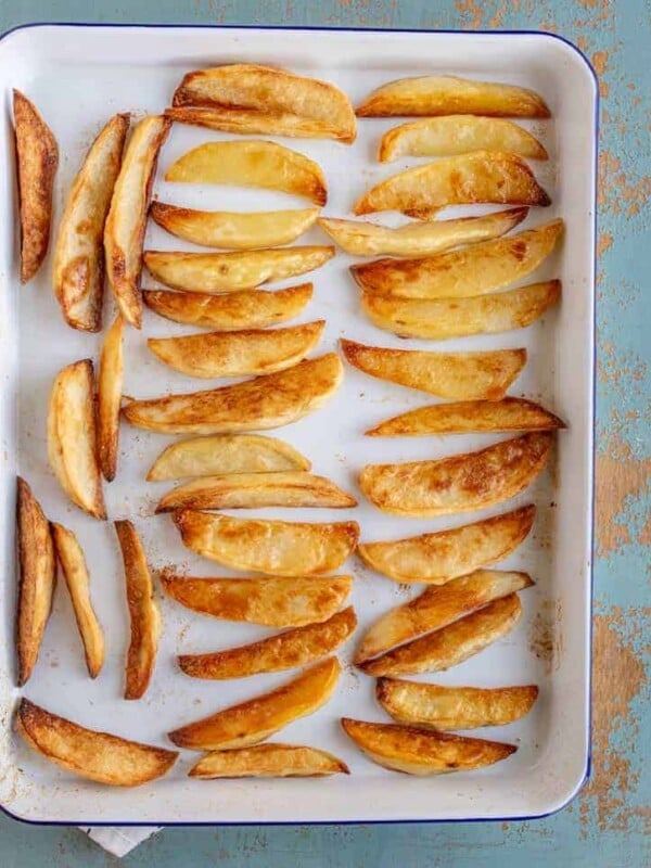 an overhead shot of oven baked French fries on a baking sheet.