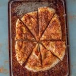 an overhead shot of no-knead refrigerated pizza dough on a pan. Baked until golden brown.