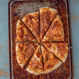 an overhead shot of no-knead refrigerated pizza dough on a pan. Baked until golden brown.