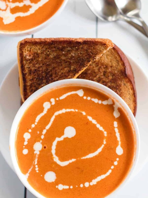Simple Cream of Tomato Soup comes together quickly to make a creamy and lush soup with canned tomatoes, some onion and garlic, a little butter, and a few splashes of chicken broth and whole cream.
