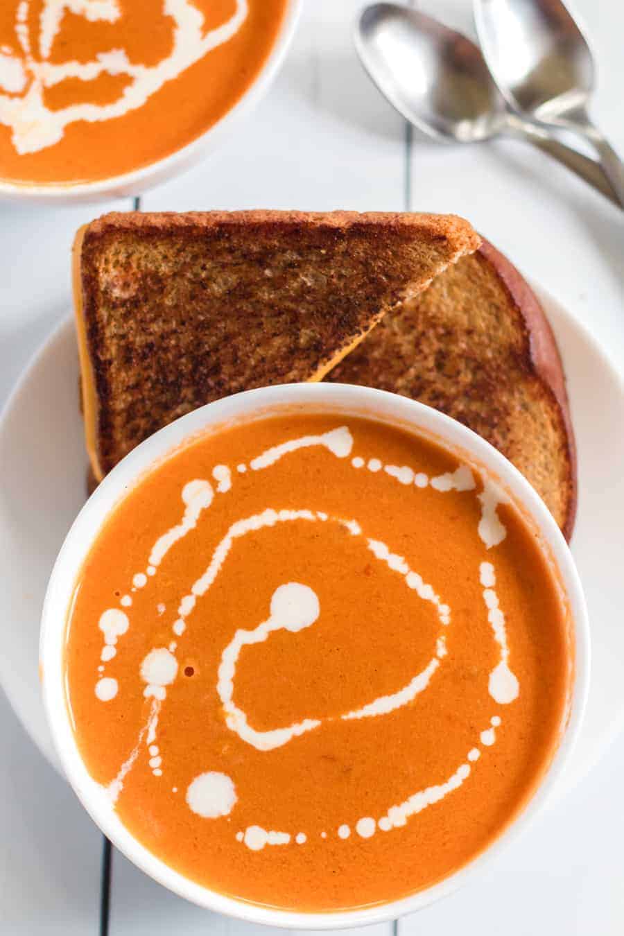 Simple Cream of Tomato Soup comes together quickly to make a creamy and lush soup with canned tomatoes, some onion and garlic, a little butter, and a few splashes of chicken broth and whole cream.