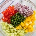 Vibrant, bright flavors come together in my Mango Salsa with red bell pepper, cucumber, red onion, cilantro, lime juice, and of course, the star of this show: fresh mango!