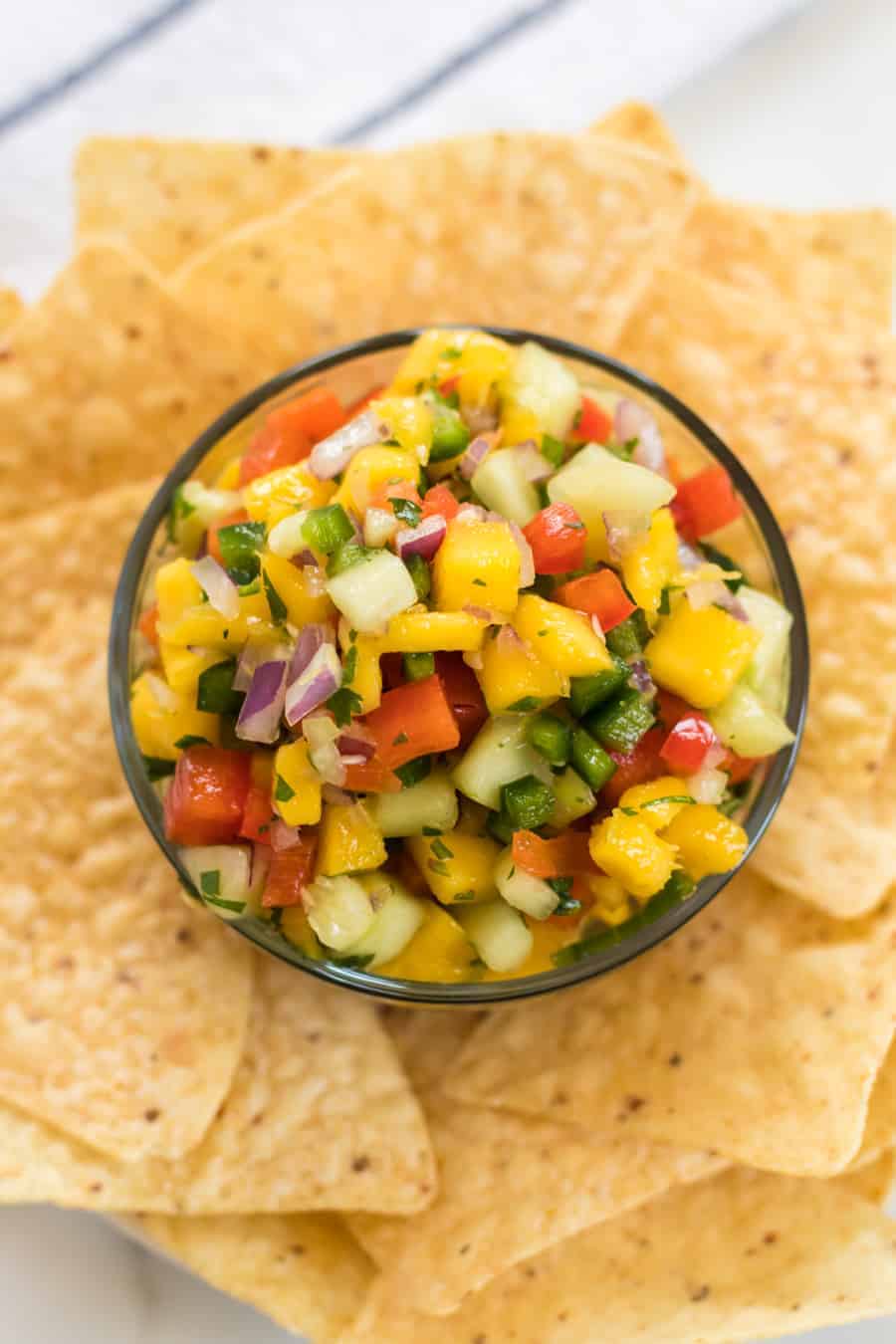 Vibrant, bright flavors come together in my Mango Salsa with red bell pepper, cucumber, red onion, cilantro, lime juice, and of course, the star of this show: fresh mango!