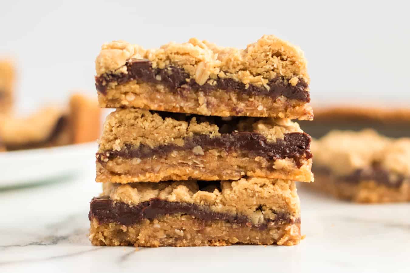 Perfectly equal parts chewy, crusty, and soft, these Peanut Butter Oat Jumbles bars are one of the best chocolate-peanut butter cookie desserts around.