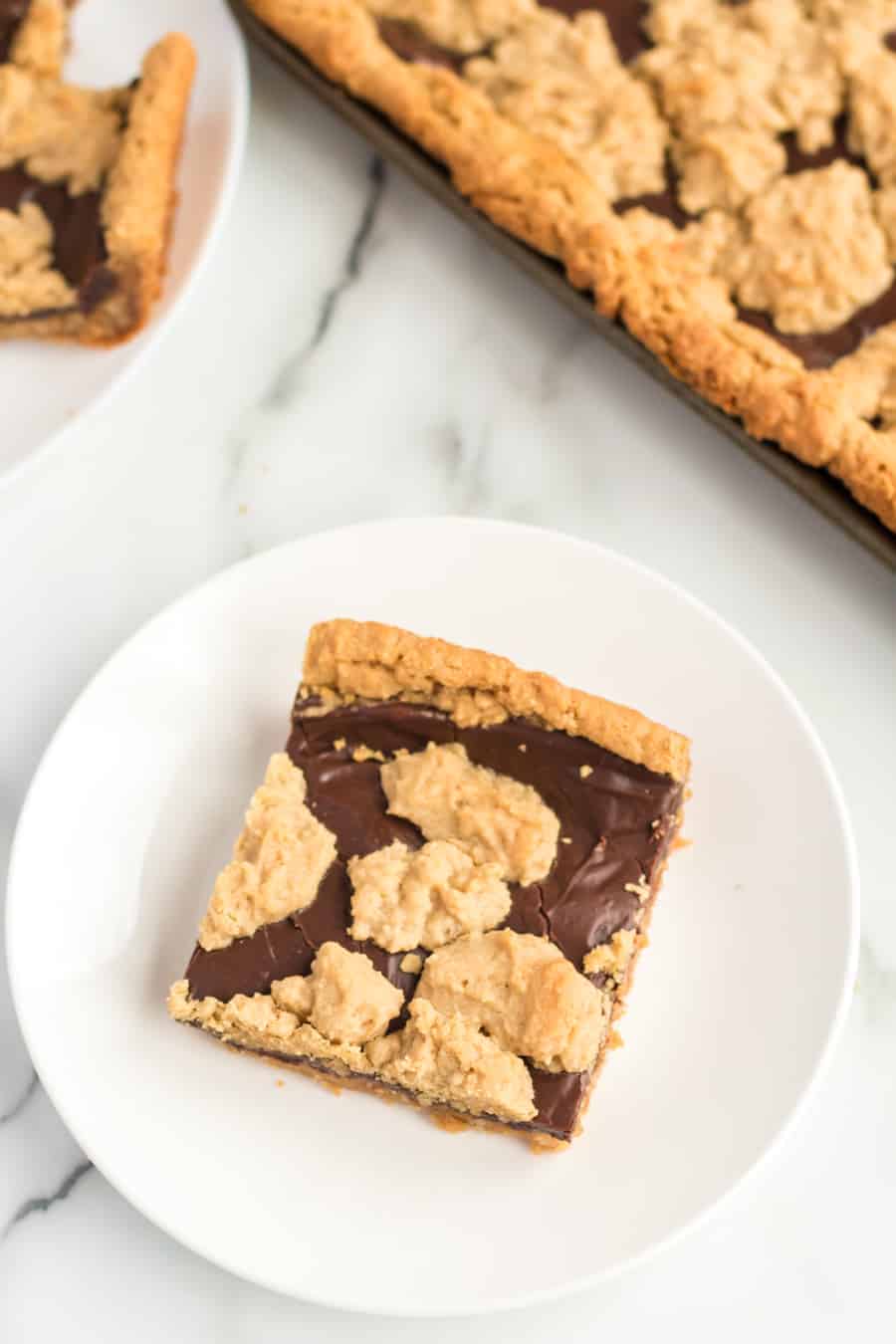 Perfectly equal parts chewy, crusty, and soft, these Peanut Butter Oat Jumbles bars are one of the best chocolate-peanut butter cookie desserts around.