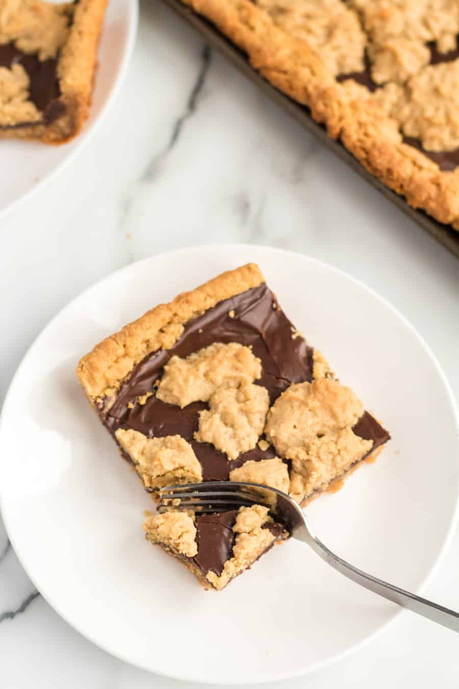 Perfectly equal parts chewy, crusty, and soft, these Peanut Butter Oat Jumbles bars are one of the best chocolate-peanut butter cookie desserts around.