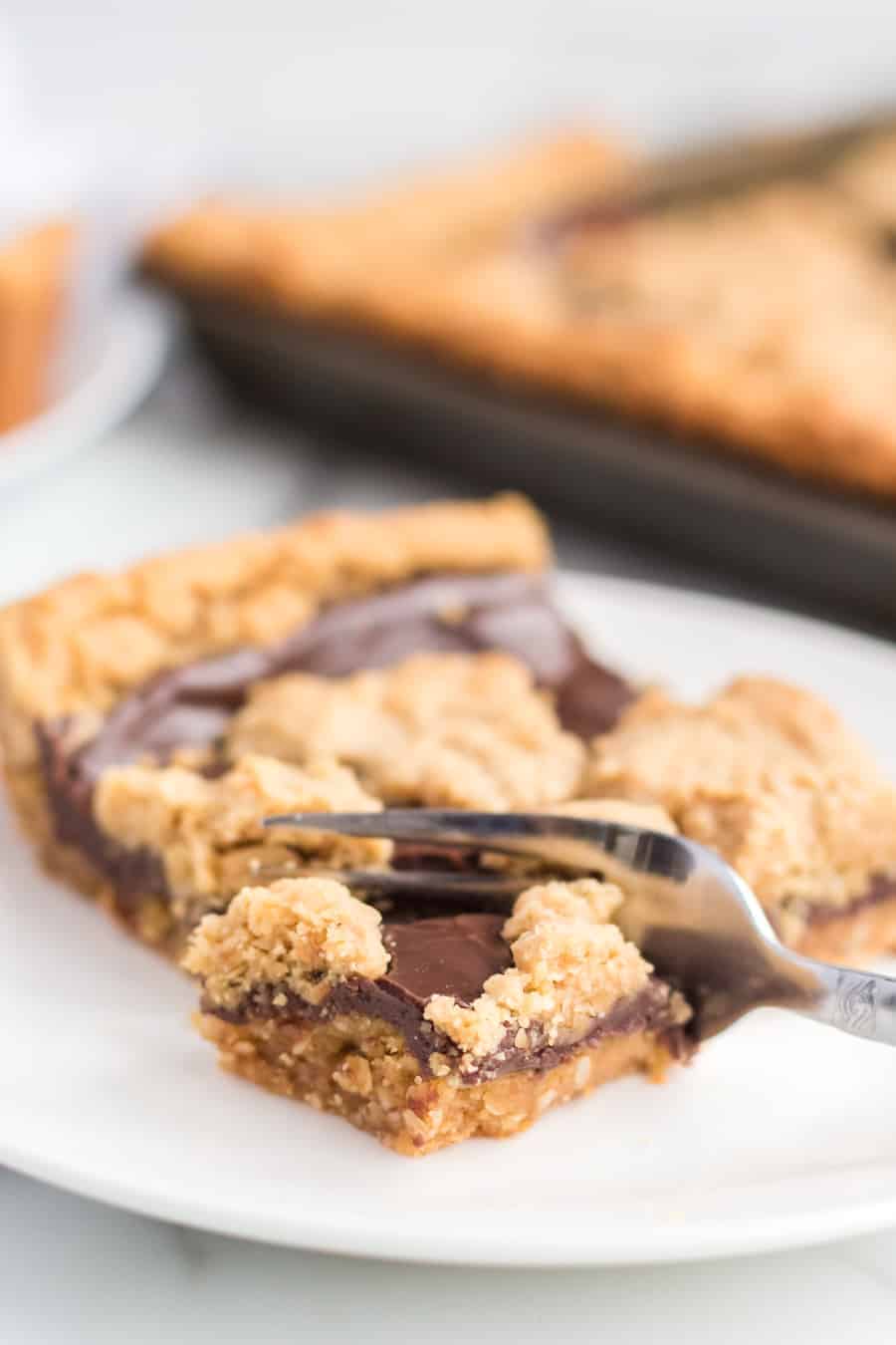 Perfectly equal parts chewy, crusty, and soft, these Peanut Butter Oat Jumbles bars are one of the best chocolate-peanut butter cookie desserts around.