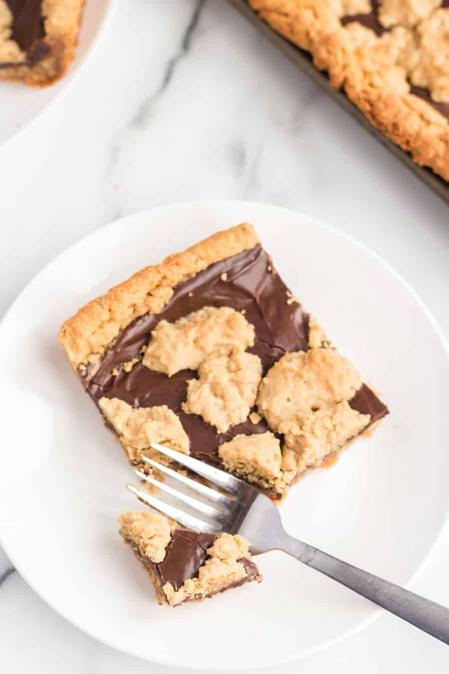 Perfectly equal parts chewy, crusty, and soft, these Peanut Butter Oat Jumbles bars are one of the best chocolate-peanut butter cookie desserts around.