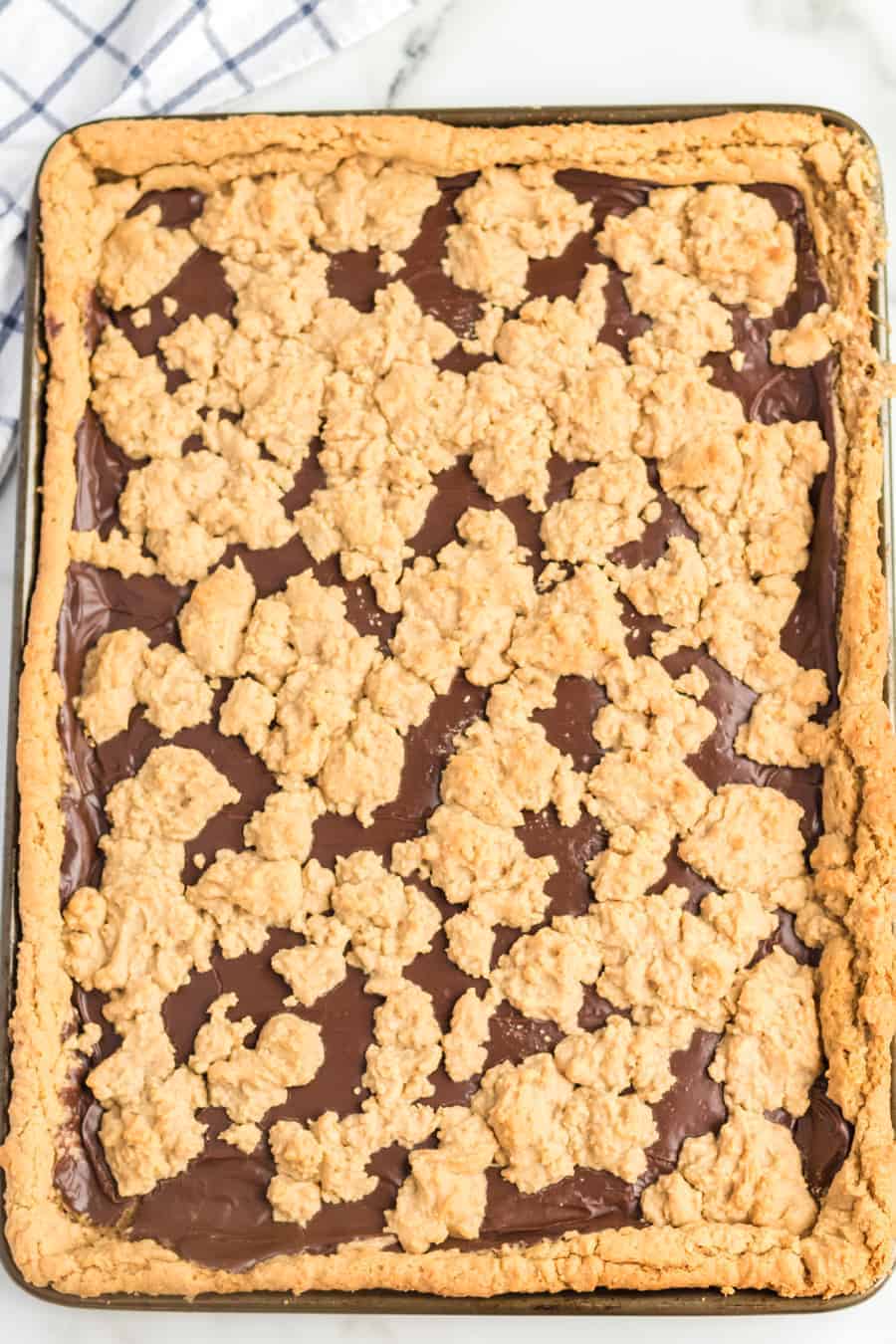 Perfectly equal parts chewy, crusty, and soft, these Peanut Butter Oat Jumbles bars are one of the best chocolate-peanut butter cookie desserts around.