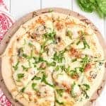 Take your homemade pizza to new heights with this recipe featuring chicken, bacon, and mushrooms slathered in melted cheese and creamy sauce.