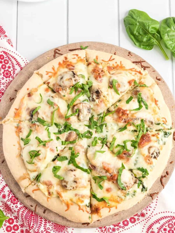 Take your homemade pizza to new heights with this recipe featuring chicken, bacon, and mushrooms slathered in melted cheese and creamy sauce.
