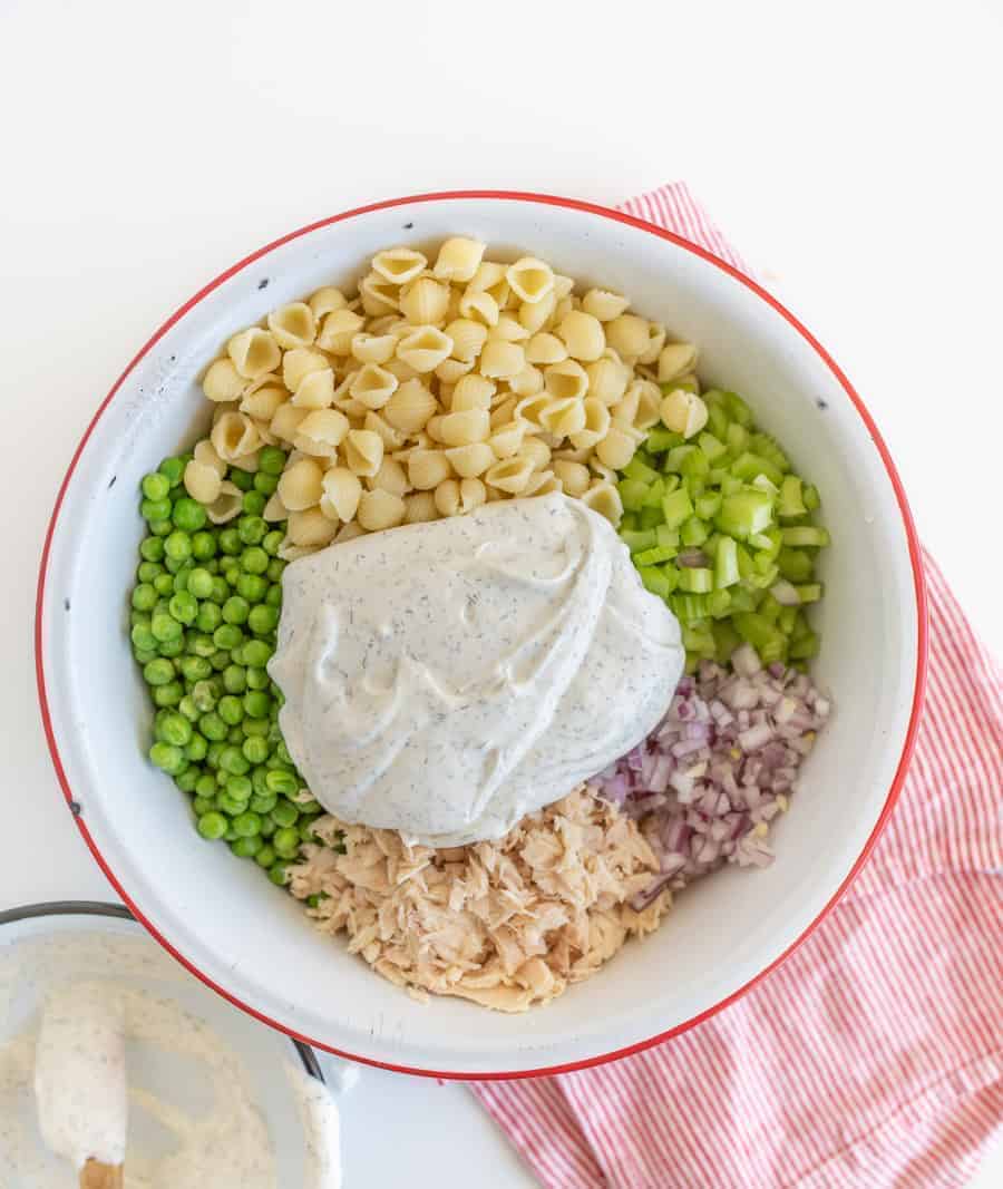 A light and refreshing Classic Tuna Pasta Salad comes together as the perfect summer side dish with white tuna, shell noodles, celery, peas, and a creamy dill sauce.
