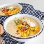 All the heartiness of a baked potato comes together in this rich and fast-as-can-be Instant Pot Loaded Baked Potato Soup, topped with shredded cheddar, crispy bacon bits, green onion, and sour cream.