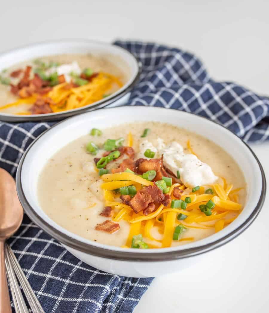 All the heartiness of a baked potato comes together in this rich and fast-as-can-be Instant Pot Loaded Baked Potato Soup, topped with shredded cheddar, crispy bacon bits, green onion, and sour cream.