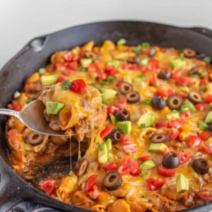 Cheesy, creamy, and packed with shell noodles, ground beef, lots of tomatoes, and all your favorite Tex-Mex toppings, one-pot Skillet Taco Pasta is as dreamy as it is filling and flavorful.