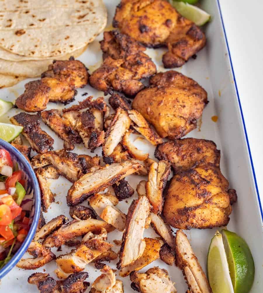 This smoky and Crispy Sheet Pan Baked Chicken Taco Meat creates tender bites of chicken thigh with the use of lime, cilantro, cumin, chili powder, and more savory spices that are perfect to wrap up in tortillas.