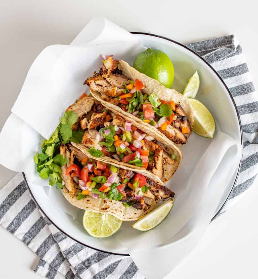 This smoky and Crispy Sheet Pan Baked Chicken Taco Meat creates tender bites of chicken thigh with the use of lime, cilantro, cumin, chili powder, and more savory spices that are perfect to wrap up in tortillas.