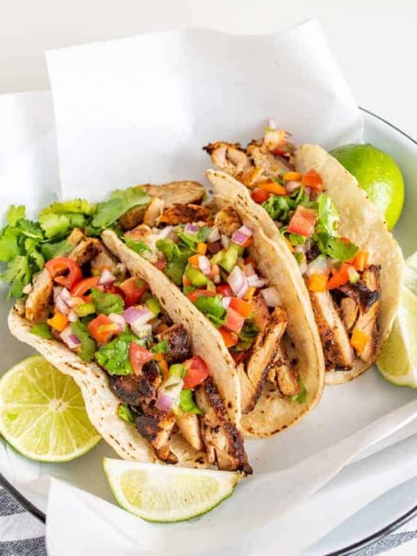 This smoky and Crispy Sheet Pan Baked Chicken Taco Meat creates tender bites of chicken thigh with the use of lime, cilantro, cumin, chili powder, and more savory spices that are perfect to wrap up in tortillas.