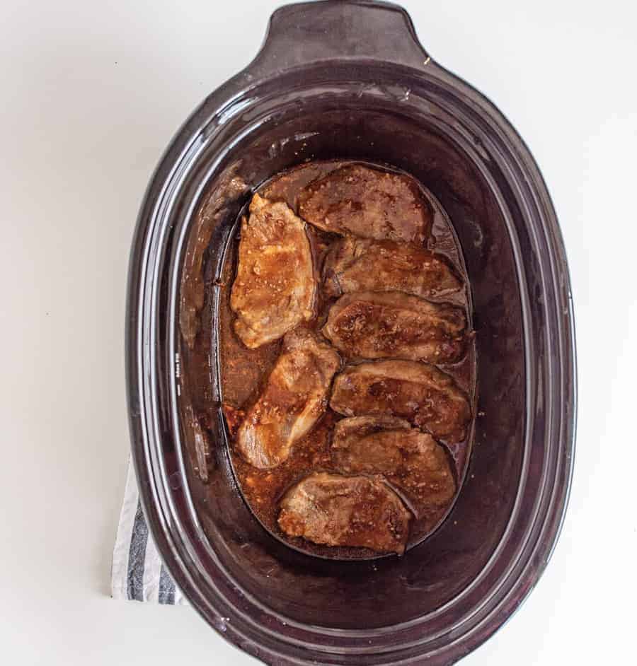 Vibrant and hearty, Slow Cooker Honey Garlic Pork Chops come together super fast with minimal ingredients--pork chops, salt and pepper, garlic, honey, soy sauce, and ketchup--and a few hours of cook time in the slow cooker.
