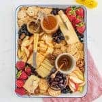The options are endless for this Everyday Cheese Board, but the trick is to get a solid combination of flavors, textures, and colors on the board! I like cheddar, Colby jack, and Swiss cheeses with jam, mustard, various types of crackers, olives, and fruit.
