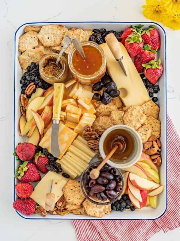 The options are endless for this Everyday Cheese Board, but the trick is to get a solid combination of flavors, textures, and colors on the board! I like cheddar, Colby jack, and Swiss cheeses with jam, mustard, various types of crackers, olives, and fruit.