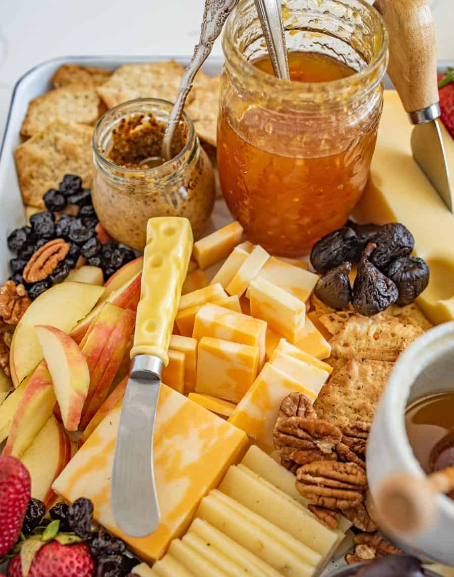 The options are endless for this Everyday Cheese Board, but the trick is to get a solid combination of flavors, textures, and colors on the board! I like cheddar, Colby jack, and Swiss cheeses with jam, mustard, various types of crackers, olives, and fruit.