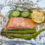 grilled salmon and vegetables in an open foil packet