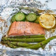 grilled salmon and vegetables in an open foil packet