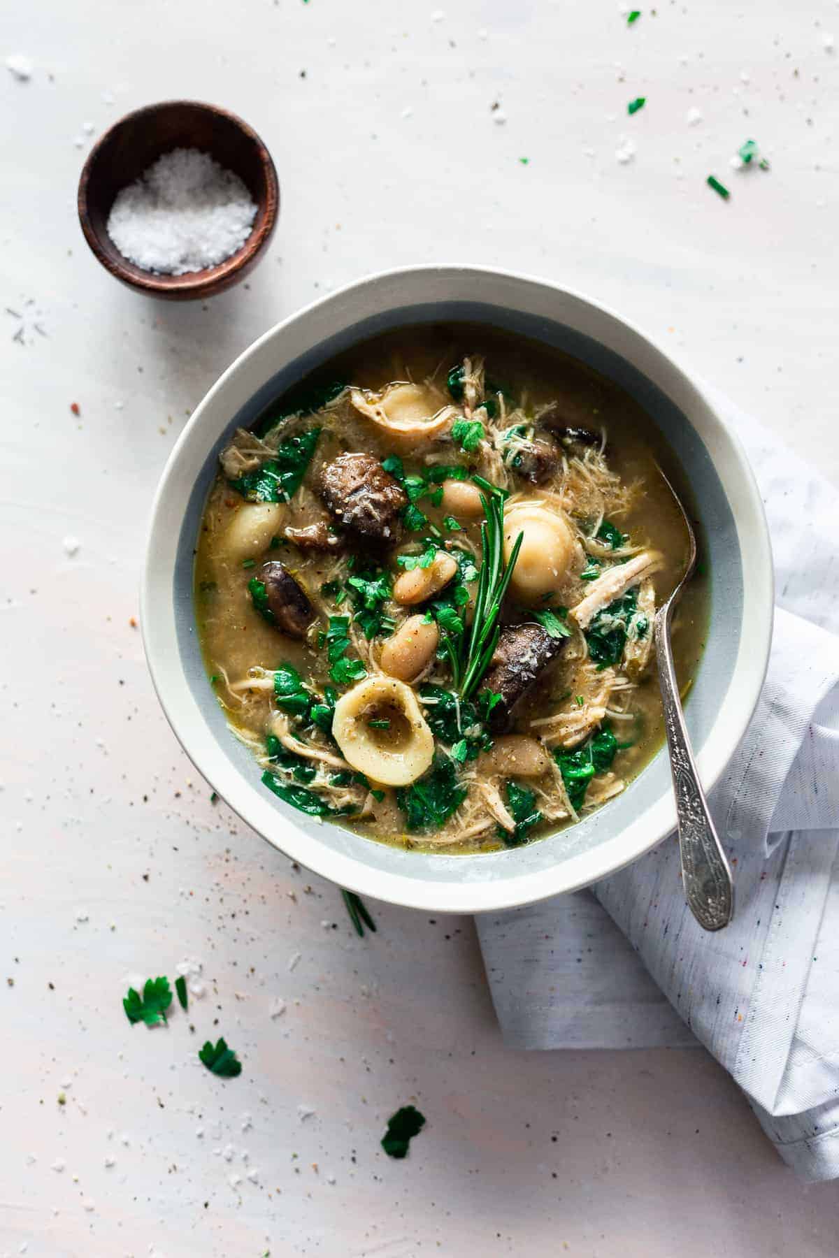 Flavorful and hearty, this Italian chicken and mushroom soup is warming to the soul and is totally easy to make a big batch of on a chilly night! Packed with flavor and delicious ingredients, you'll love this soup for fall and winter nights when all you want is something warm and comforting. #italiansoup #soup #chickensoup #mushroomsoup #souprecipes #italianrecipes