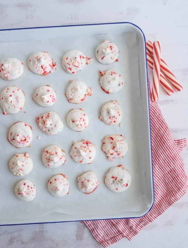candy cane meringue cookies on parchment