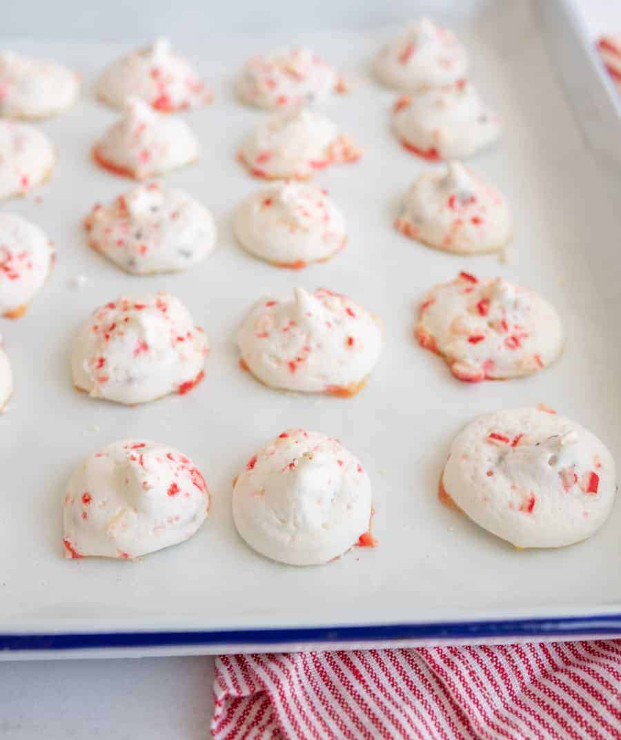 candy cane meringue cookies on a baking sheet ready for the oven.