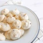 white and chocolate drop meringue cookies in a white bowl