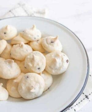 white and chocolate drop meringue cookies in a white bowl