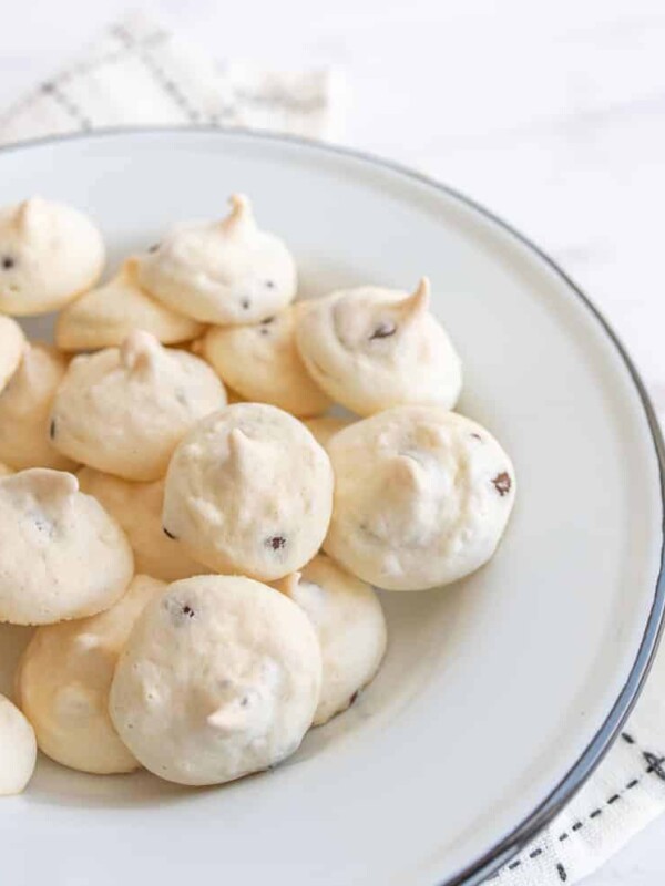 white and chocolate drop meringue cookies in a white bowl