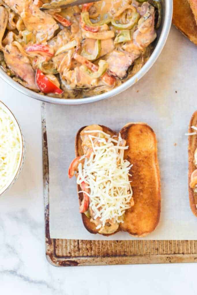 sesame bun grilled and open with shredded cheese