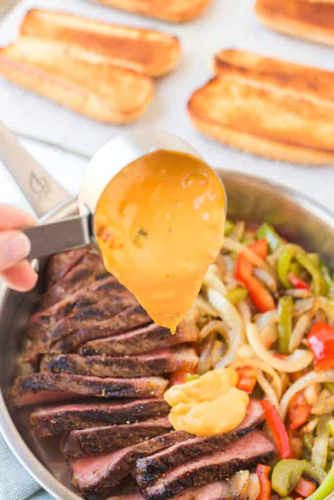 sauce scooped onto steak and veggies