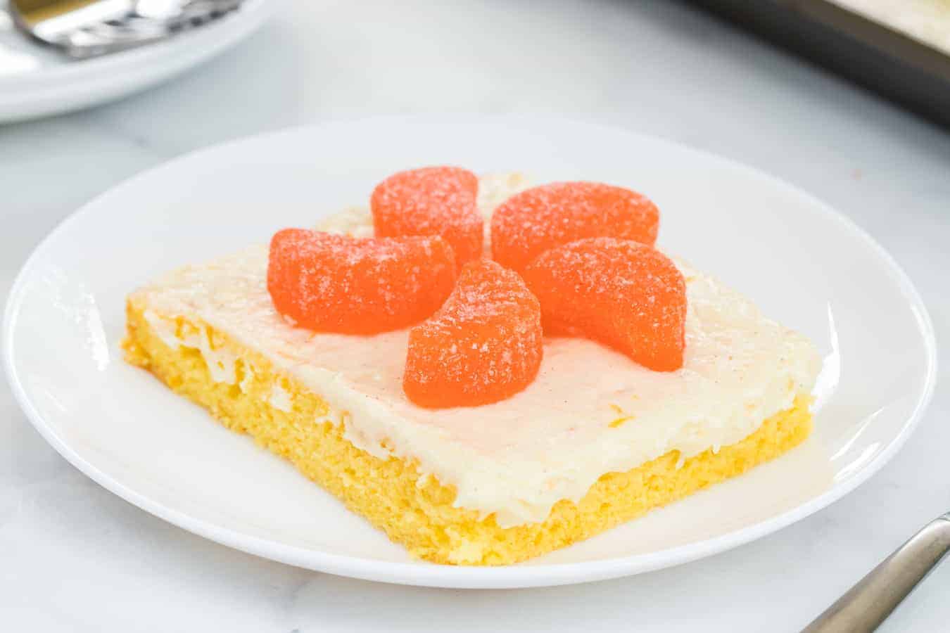 Fresh orange cake with orange vanilla bean icing is a vibrant and zesty sheet cake that's a breeze to whip up and even easier to enjoy. #orangecake #sheetcake #cake #baking #oranges #orangeicing