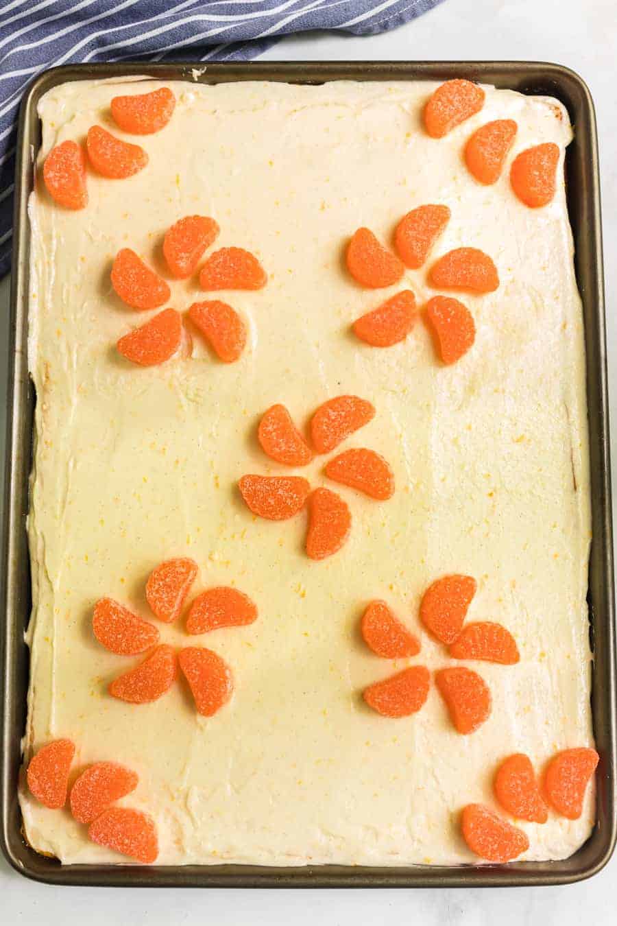 Fresh orange cake with orange vanilla bean icing is a vibrant and zesty sheet cake that's a breeze to whip up and even easier to enjoy. #orangecake #sheetcake #cake #baking #oranges #orangeicing