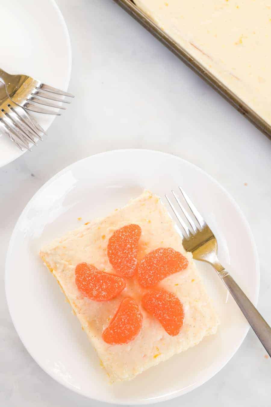 Fresh orange cake with orange vanilla bean icing is a vibrant and zesty sheet cake that's a breeze to whip up and even easier to enjoy. #orangecake #sheetcake #cake #baking #oranges #orangeicing