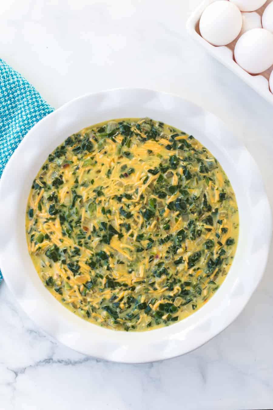 Straightforward yet flavorful, crustless spinach quiche is an easy and healthy breakfast that you can customize or keep simple! #spinachquiche #crustlessquiche #breakfast #quiche #healthybreakfasts