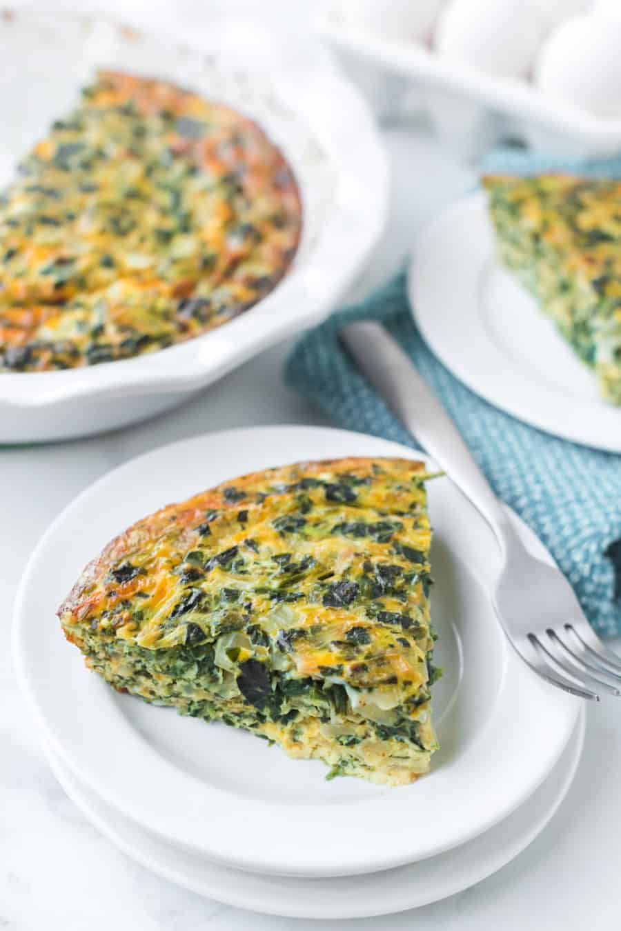 crustless spinach quiche on a white plate