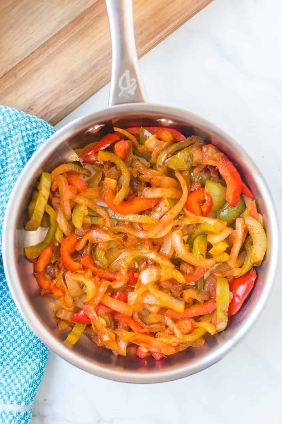 bell peppers and onions sautéed in a pot