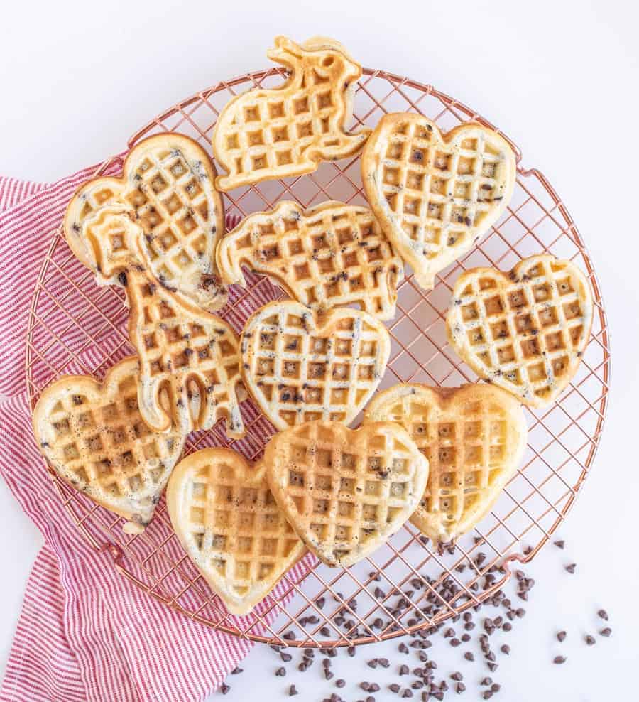heart shaped chocolate chip waffles on a cooling rack.