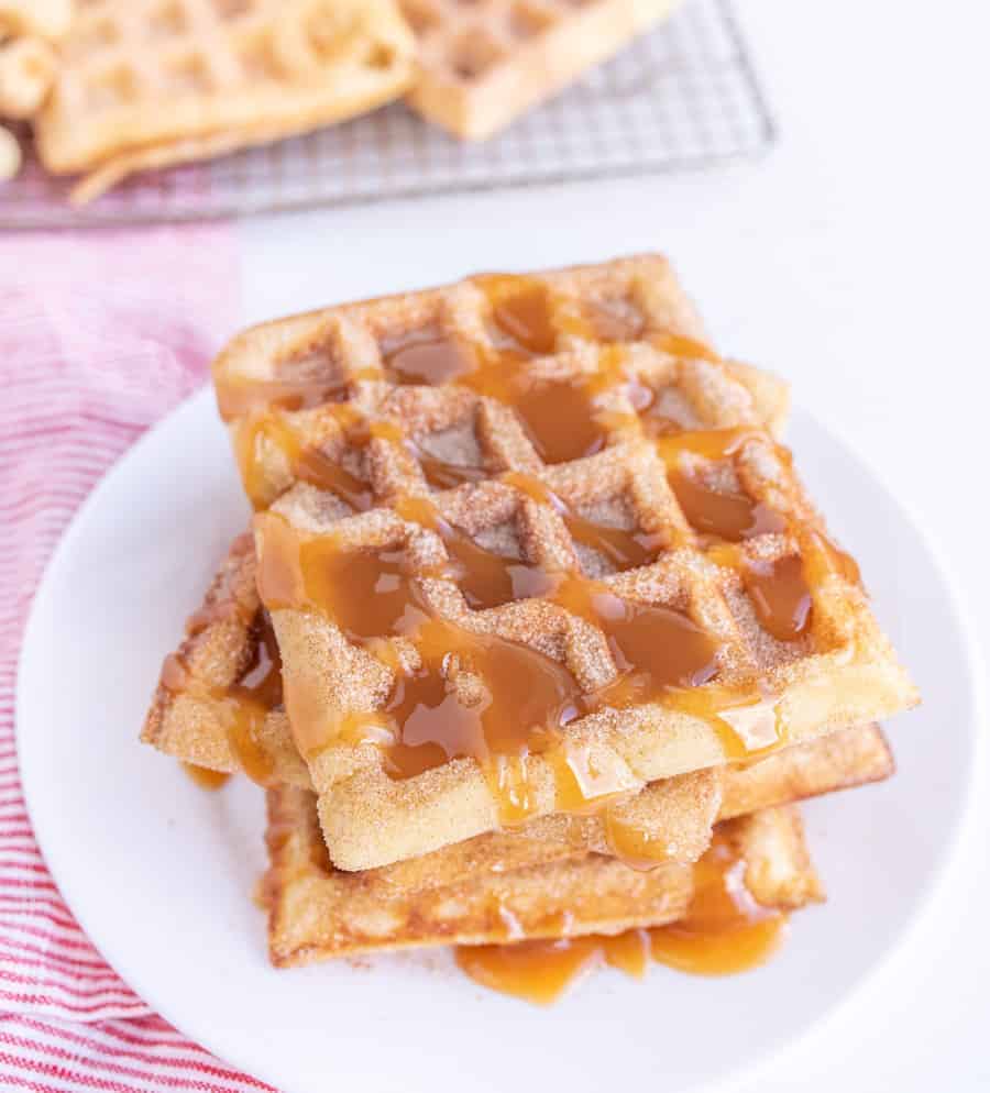 churro waffles on a plate with caramel sauce