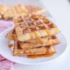 churro waffles on a plate with caramel sauce