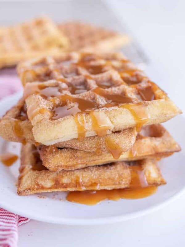 churro waffles on a plate with caramel sauce