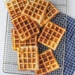 savory square waffles stacked on a cooling rack