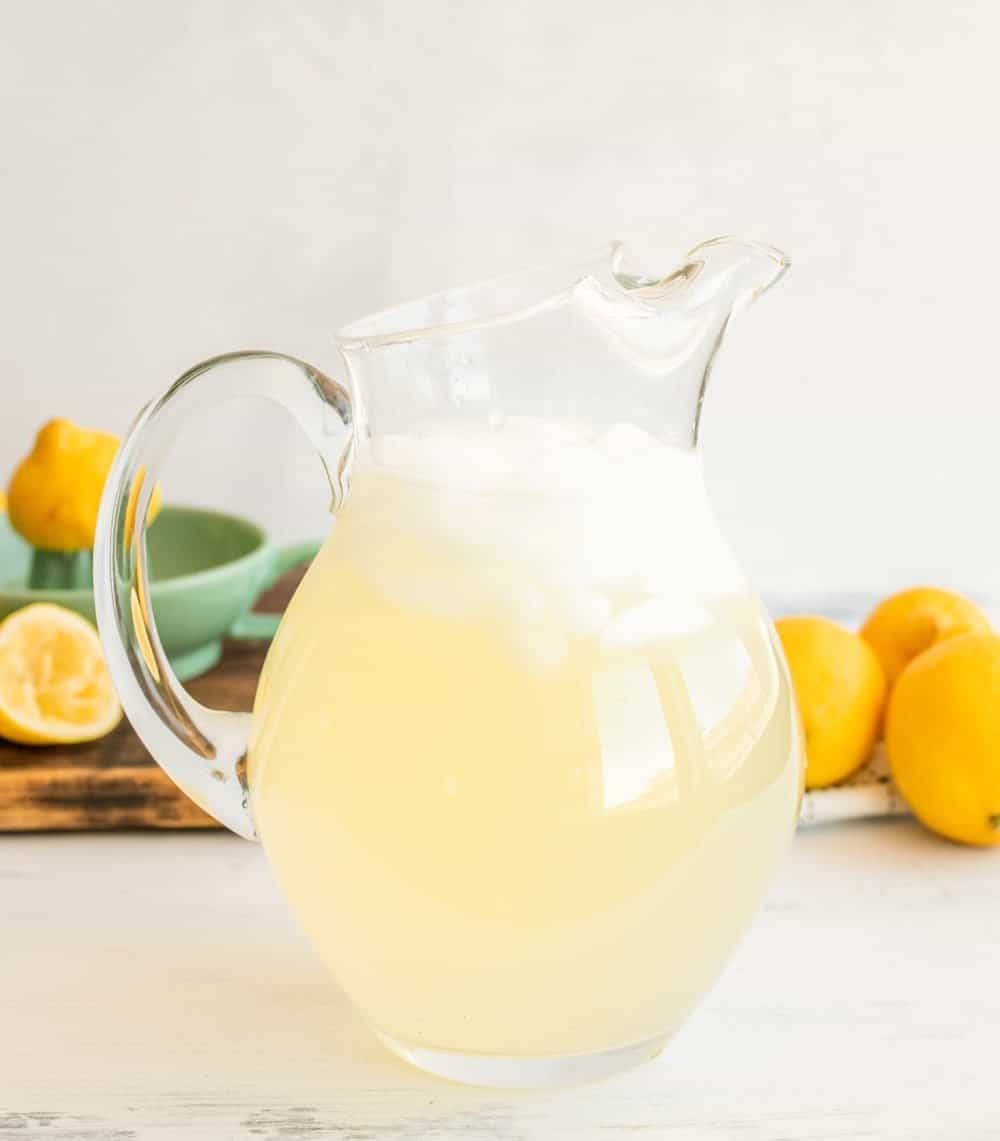 a glass pitcher of iced homemade lemonade