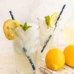 two glasses of iced homemade lemonade with blue star paper straws